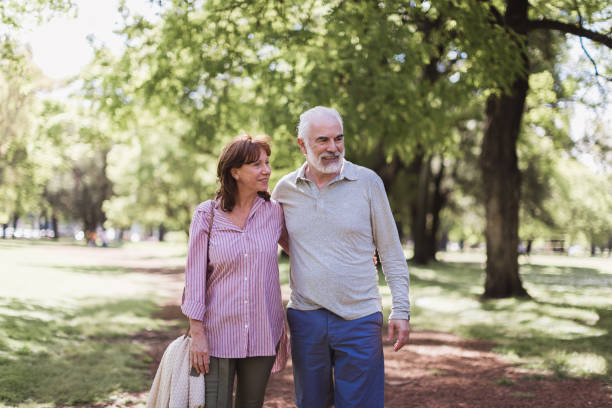 istock Senior couple walking in a park 1189531386