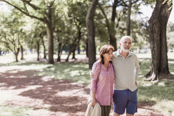 istock Senior couple walking in a park 1189531428