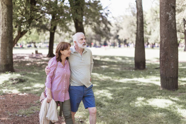 istock Senior couple walking in a park 1189531466