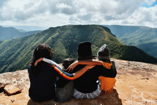 istock Family members looking at valley views while Sitting on the cliff 1189533786