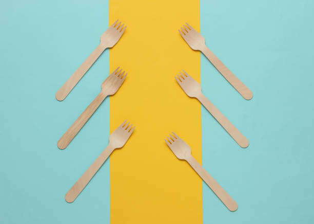 istock Wooden forks on a colored paper background. Top view 1189534503