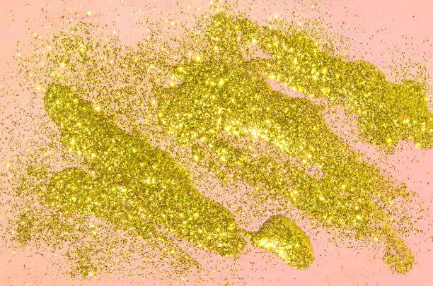 istock Abstract luxurious liquid golden lights glitter on pastel pink background. 1189535499