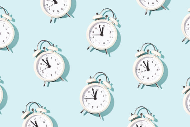 istock Pattern made of white alarm clocks. 1189535845