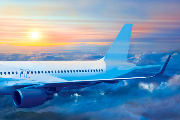 istock Passenger jet plane flies above the sunset clouds 1189541969