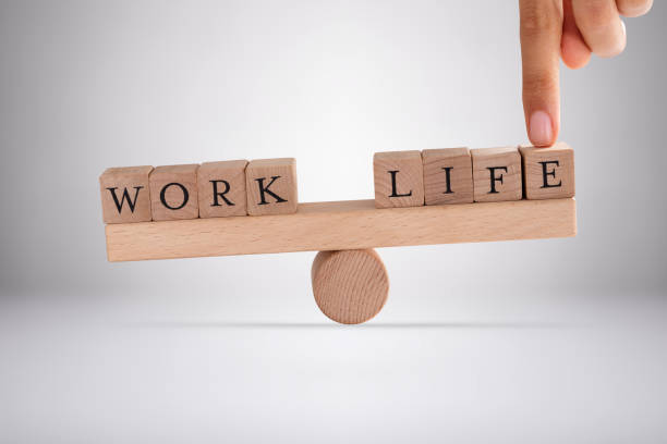 istock Person's Finger Balancing Work And Life Blocks 1189542191