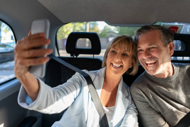 istock Couple taking a selfie while riding on a taxi 1189547010