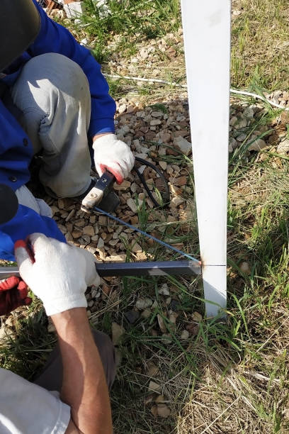 istock Worker with welding machine welds the fence around the house. 1189549249
