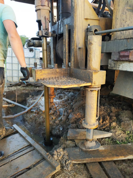 istock A groundwater drilling machine installed on an old truck performs well drilling on a private site. 1189549390