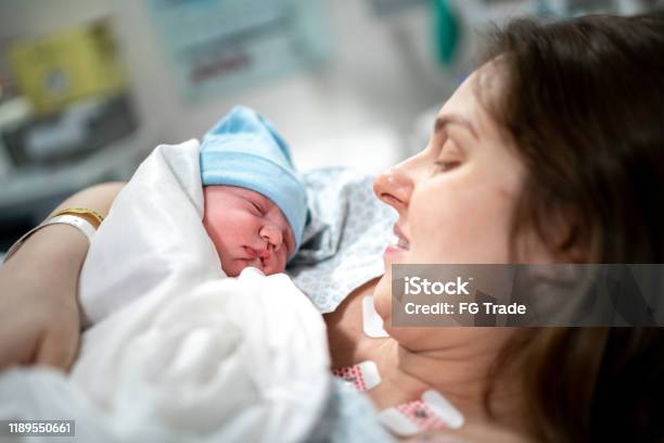 Mother Looking At Her Baby For The First Time Stock Photo - Download Image Now - Caesarean Section, Labor - Childbirth, Mother