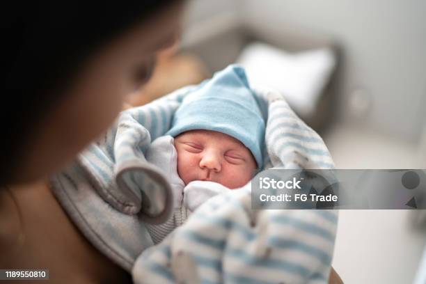 Women Holding And Looking At Her Godson At Hospital Stock Photo - Download Image Now