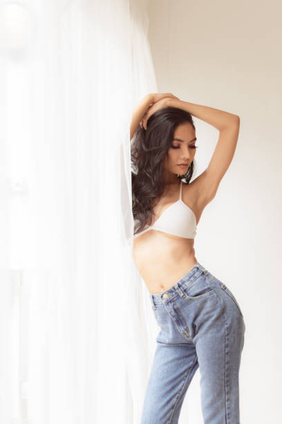istock Beautiful woman in a posture by the window. 1189551868