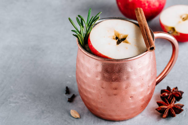 istock Apple Cider Moscow Mule cocktail with cinnamon stick and rosemary in copper 1189551914