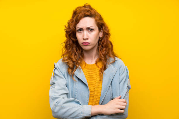istock Redhead woman over isolated yellow background sad 1189552741