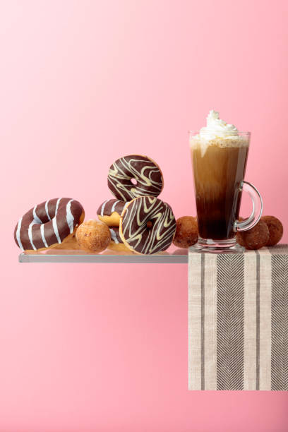 istock Chocolate donuts and coffee cocktail with cream. 1189554733