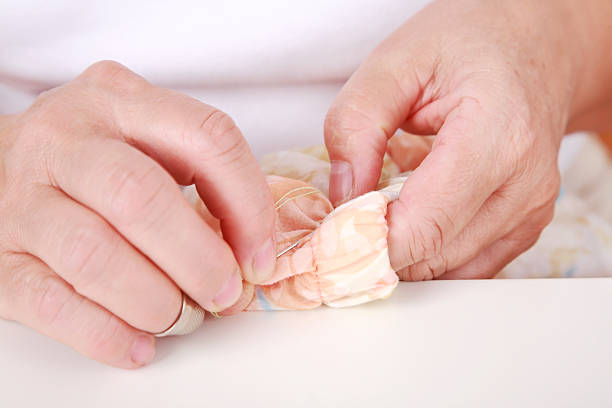 istock Elderly woman sewing 118955562