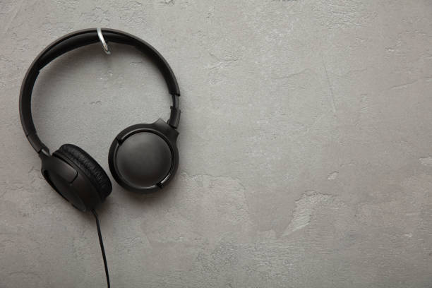 istock Headphones hangs on a hook on concrete background 1189556097