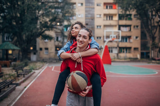 istock Happy couple having fun playing basketball 1189558605