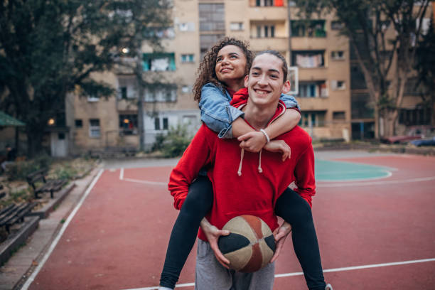 istock Happy couple having fun playing basketball 1189558641