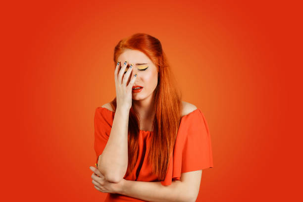 istock Stressed redhead woman about to cry, depressed 1189558782