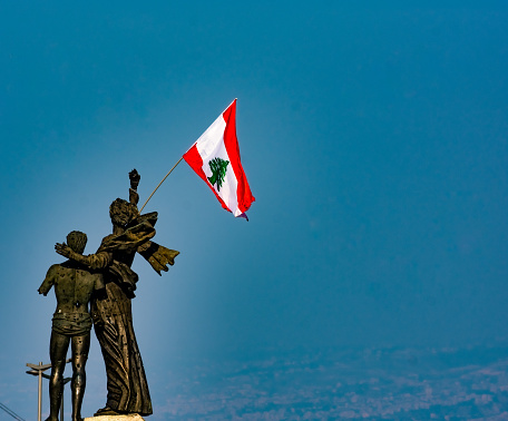 Beirut Lebanon 11/23/2019 The monument at Martyrs' Square in Beirut by Italian sculptor Marino Mazzacurati with the Lebanese national flag. Martyrs' square is the Beirut central square.