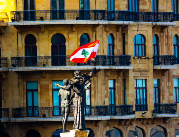 Monument at martyrs square in Beirut with Lebanese flag Beirut Lebanon 11/23/2019 The monument at Martyrs' Square in Beirut by Italian sculptor Marino Mazzacurati with the Lebanese national flag. Martyrs' square is the Beirut central square. lebanon beirut stock pictures, royalty-free photos & images