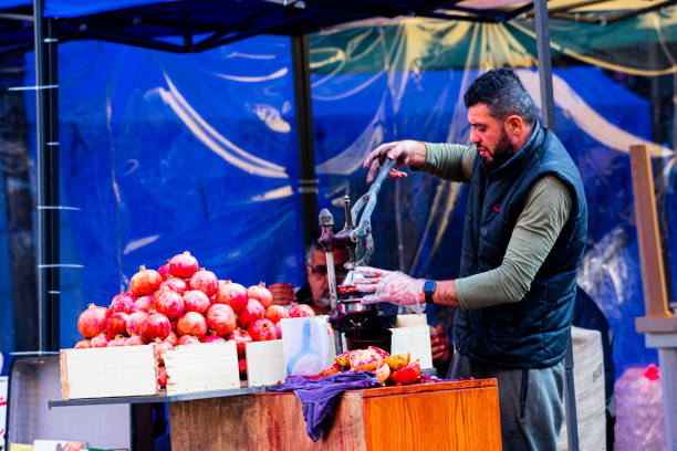 Beirut Lebanon 11/23/2019 A Vendor on the streets of Beirut is producing Pomegranate juice on his market stand