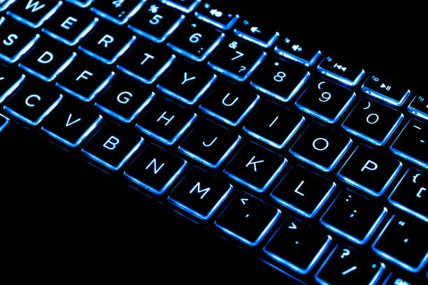 istock Close up view of a modern laptop computer keyboard keys. Soft lightning in blue tones. Pc computer keyboard close up 1189559801