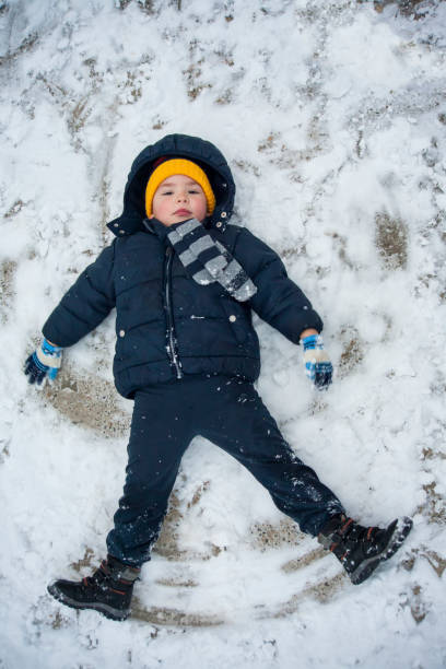istock The boy lies in the snow 1189560254