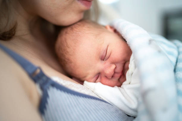 istock Baby sleeping with his mother 1189561533