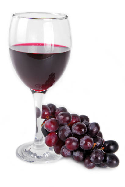 istock red wine glass with red grapes isolated on white 1189562463