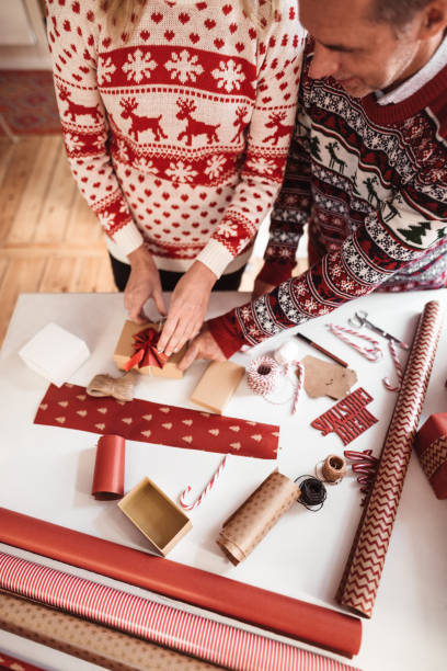 istock couple preparing the packages for christmas 1189562710