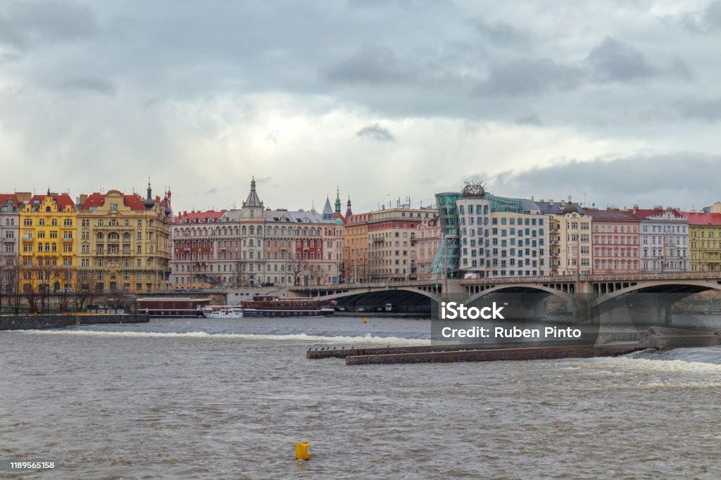 prague facade Wide view from one side of the river into prague facade in a overcast day Achievement Stock Photo