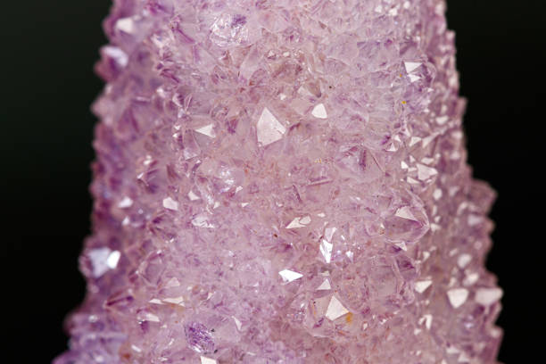 Close-up of an amethyst crystal on a white background.