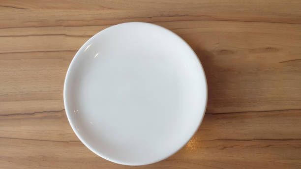 istock White food plate on the wood table 1189567668