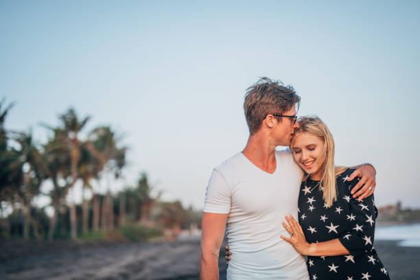 istock Couple wakling on the beach 1189567682