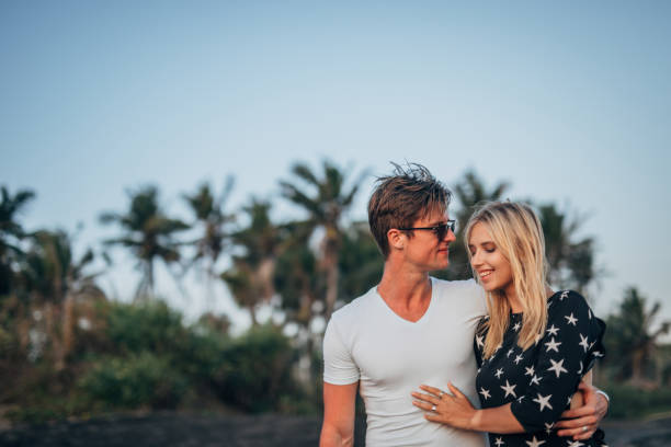 istock Couple wakling on the beach 1189567796