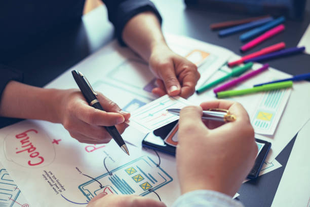 istock Creative planning and working mobile application design team in the office. 1189567797