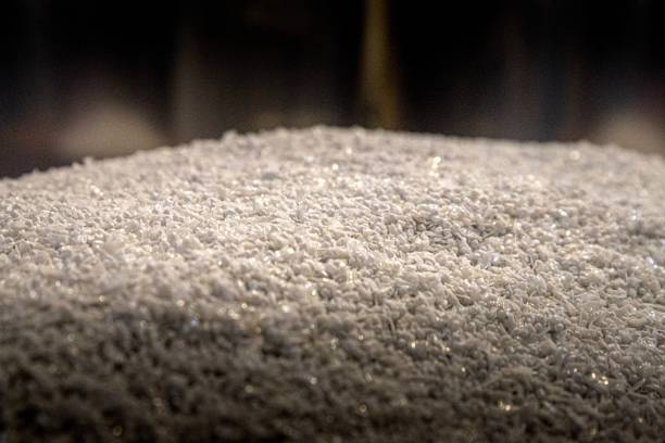 Pile of shredded Polyethylene terephthalate post industrial resin scrap prepared for recycling stock photo