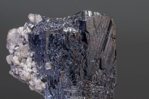 istock macro mineral Acanthite stone on a black background 1189569124