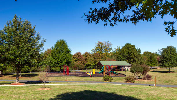 istock Suburban Playground with a Pavilon and Jogging Trail surrounded by shade trees 1189569457