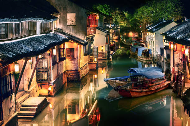 illuminated Zhouzhuang water town at night, Jiangsu, China night view of illuminated Zhouzhuang water town, Jiangsu, China water town zhouzhuang china stock pictures, royalty-free photos & images