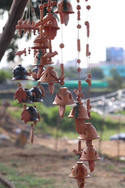 brown colored hand made wind chime made of porcelain ceramics clay - christmas decoration campanula decoration christmas imagens e fotografias de stock