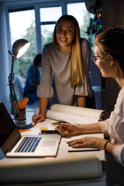 istock Two young female coworkers making plans for further projects at work 1189571524