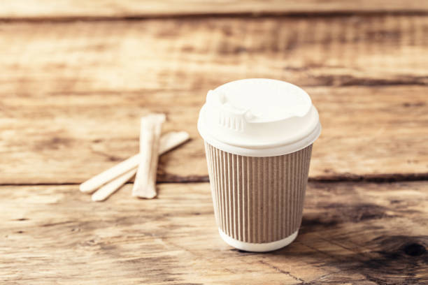 Coffee or tea in a paper cup with a lid