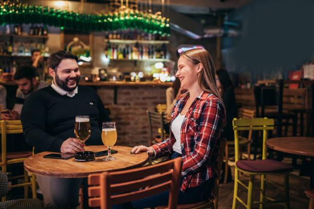 istock Happy couple drinking beer on a date night 1189572973