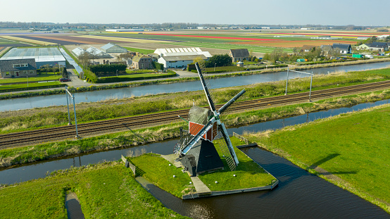 9 june 2018, Oterleek, Holland. Aerial view of a old dutch traditional windmill on the rural countryside in The Netherlands with a dike, canal and a small road.