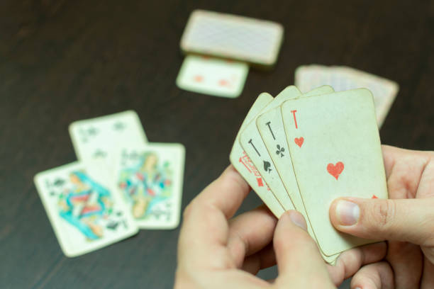 istock hold playing cards in hand, close up, during the game 1189576542