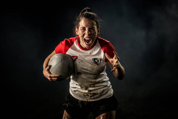istock Female rugby player holding ball 1189578692