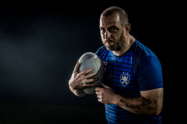 istock Rugby player holding ball 1189578695