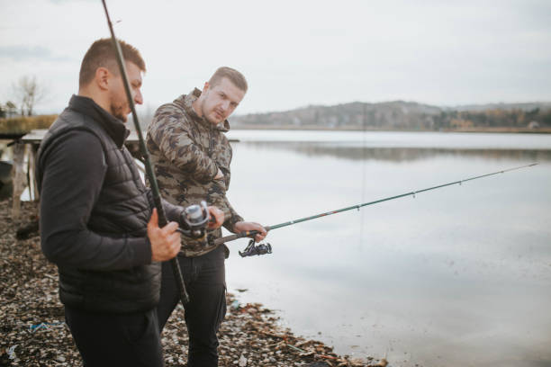istock Young men fishing 1189579098